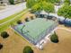 Overhead view of a fenced basketball court featuring new nets, landscaping and nearby benches at 14618 Scottburgh Glen Dr, Wimauma, FL 33598