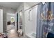 Bathroom shower with tiled walls and colorful curtain at 14618 Scottburgh Glen Dr, Wimauma, FL 33598