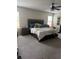 Spacious main bedroom with large bed, plush carpet, neutral tones, and natural light at 14618 Scottburgh Glen Dr, Wimauma, FL 33598