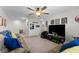 Large bonus room with a ceiling fan, comfortable seating, and decor at 14618 Scottburgh Glen Dr, Wimauma, FL 33598