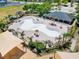 Aerial shot of an empty community pool featuring seating, shade, and recreational space enhancing community living at 14618 Scottburgh Glen Dr, Wimauma, FL 33598