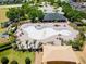 Overhead shot of the community pool and clubhouse featuring ample lounge seating and a nearby playground at 14618 Scottburgh Glen Dr, Wimauma, FL 33598