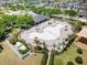 Aerial shot of a large, empty community pool area featuring lounge chairs, palm trees, and a covered pavilion at 14618 Scottburgh Glen Dr, Wimauma, FL 33598