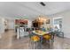 Open-concept dining area with a view of the kitchen, modern lighting and tiled flooring at 14618 Scottburgh Glen Dr, Wimauma, FL 33598