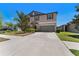Inviting two-story home showcasing a well-manicured front yard and a spacious driveway at 14618 Scottburgh Glen Dr, Wimauma, FL 33598