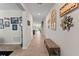 Long hallway with tiled floors, neutral walls, and stylish decorative wall hangings at 14618 Scottburgh Glen Dr, Wimauma, FL 33598