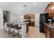 Kitchen with granite counters, stainless appliances, dark cabinets, and tile flooring at 14618 Scottburgh Glen Dr, Wimauma, FL 33598