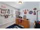 Home office featuring a large wooden desk, sports memorabilia and ample shelving for organization at 14618 Scottburgh Glen Dr, Wimauma, FL 33598