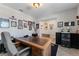 A spacious office features a large desk and chair, multiple pictures, and ample room to work at 14618 Scottburgh Glen Dr, Wimauma, FL 33598