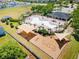 Aerial view of the community playground featuring shade structures, swings, and play areas surrounded by lush landscaping at 14618 Scottburgh Glen Dr, Wimauma, FL 33598