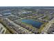 An aerial view of a large planned community with many lakes and single Gathering homes at 15613 Charr Island St, Sun City Center, FL 33573