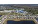 An aerial view of a block of homes next to a school and a large pond in the neighborhood at 15613 Charr Island St, Sun City Center, FL 33573