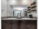 Bathroom featuring double vanity with granite countertops and decorative shelving for an organized and stylish space at 15613 Charr Island St, Sun City Center, FL 33573