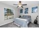 Cozy bedroom showcasing a comfortable bed, ceiling fan, a bright window, and stylish wall art at 15613 Charr Island St, Sun City Center, FL 33573