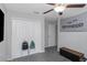 Neutrally decorated bedroom featuring a closet with sports bags and a ceiling fan at 15613 Charr Island St, Sun City Center, FL 33573