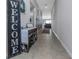 Inviting entryway with neutral tones, tile flooring, and stylish bench and welcome sign at 15613 Charr Island St, Sun City Center, FL 33573