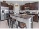 Beautiful kitchen with granite counters, stainless steel appliances, and convenient seating at the island at 15613 Charr Island St, Sun City Center, FL 33573