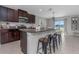 Stylish kitchen featuring granite countertops, stainless steel appliances, and barstool seating at 15613 Charr Island St, Sun City Center, FL 33573