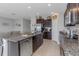 Open concept kitchen with stainless steel appliances, granite countertops, and a spacious layout at 15613 Charr Island St, Sun City Center, FL 33573