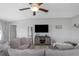 Comfortable living room with gray sectional sofa, media center, and neutral decor at 15613 Charr Island St, Sun City Center, FL 33573