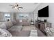 Spacious living room featuring large sectional sofa, water view, and natural light at 15613 Charr Island St, Sun City Center, FL 33573