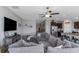 Inviting living room with a large gray sectional sofa and views into the kitchen at 15613 Charr Island St, Sun City Center, FL 33573