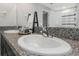 Close-up of a bathroom vanity with double sinks, a granite countertop, and a modern faucet at 15613 Charr Island St, Sun City Center, FL 33573