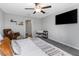 Bright main bedroom featuring neutral tones, a leather chair, and minimal decor at 15613 Charr Island St, Sun City Center, FL 33573