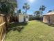 Spacious backyard with storage shed, gazebo, and lush green lawn, ideal for outdoor activities and relaxation at 200 82Nd N Ave, St Petersburg, FL 33702