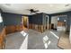 Living room showing multiple doorways, ample natural light, and a ceiling fan at 200 82Nd N Ave, St Petersburg, FL 33702