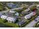 Aerial view of a condo community with a pond and pool at 2087 Hunters Glen Dr # 126, Dunedin, FL 34698