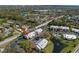 Overhead view of condo complex with pond and community pool at 2087 Hunters Glen Dr # 126, Dunedin, FL 34698