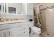 Bright bathroom features a vanity with sink, toilet, and shower with decorative tile at 2087 Hunters Glen Dr # 126, Dunedin, FL 34698