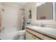 Bright bathroom featuring a shower-tub combination with modern vanity and neutral decor at 2087 Hunters Glen Dr # 126, Dunedin, FL 34698