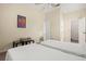 Cozy bedroom featuring two twin beds, a ceiling fan, and two entry doors at 2087 Hunters Glen Dr # 126, Dunedin, FL 34698