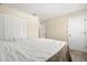 Bedroom with a large bed, closet with bi-fold doors and ensuite bathroom at 2087 Hunters Glen Dr # 126, Dunedin, FL 34698