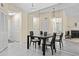 Dining area featuring mirrored wall, tile floors, and traditional furnishings, open to the living area at 2087 Hunters Glen Dr # 126, Dunedin, FL 34698