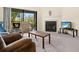 Cozy living room featuring a fireplace, balcony access, and comfortable seating at 2087 Hunters Glen Dr # 126, Dunedin, FL 34698