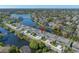 Beautiful aerial view showcases townhomes by a lake surrounded by trees and lush greenery at 2270 Spring Lake Ct, Clearwater, FL 33763