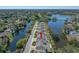 Aerial view of townhomes nestled by scenic lakes, lush trees, and a well-maintained neighborhood, creating a serene environment at 2270 Spring Lake Ct, Clearwater, FL 33763