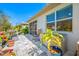 Charming backyard with paved patio, outdoor seating, plants, landscaping, and white exterior at 2270 Spring Lake Ct, Clearwater, FL 33763