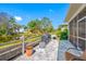 A serene backyard featuring a pond view, lush landscaping, and a paver patio with outdoor grill at 2270 Spring Lake Ct, Clearwater, FL 33763