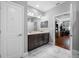 Bathroom with double sink vanity and marble tile flooring, and an open view of the office space at 2270 Spring Lake Ct, Clearwater, FL 33763