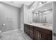 Bright bathroom features a double sink vanity with marble countertops, large mirrors, and elegant lighting at 2270 Spring Lake Ct, Clearwater, FL 33763