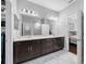 Elegant bathroom featuring a dual sink vanity with dark wood cabinets and marble flooring at 2270 Spring Lake Ct, Clearwater, FL 33763