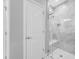 Walk-in shower with glass door, decorative tile, and bench seating at 2270 Spring Lake Ct, Clearwater, FL 33763
