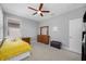 Cozy bedroom features a ceiling fan, a window with blinds and a twin bed with a yellow blanket at 2270 Spring Lake Ct, Clearwater, FL 33763