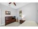 Cozy bedroom with dresser, television, guitar, neutral walls and carpet, illuminated by natural light at 2270 Spring Lake Ct, Clearwater, FL 33763