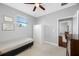 Neutral bedroom features a twin bed, ceiling fan, window with blinds and large white wardrobe at 2270 Spring Lake Ct, Clearwater, FL 33763