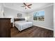 Spacious bedroom boasts wood floors, a ceiling fan, and a large window for natural light at 2270 Spring Lake Ct, Clearwater, FL 33763